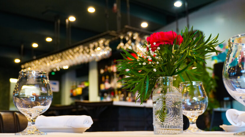 Elegant Bayshore Lounge table setting with flowers, glassware, and bar atmosphere for private dining and events.